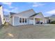 Rear view of a light blue home featuring a covered patio and lush green lawn at 105 Bluff Isle Ct, Summerville, SC 29486