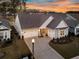Charming home featuring a three-car garage, well-manicured lawn, and inviting curb appeal at 105 Bluff Isle Ct, Summerville, SC 29486