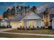 Attractive home with a two-car garage, beautiful landscaping, and a warm, welcoming facade at 105 Bluff Isle Ct, Summerville, SC 29486