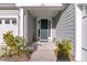 Close-up of a welcoming front entrance with a dark-colored door and sidelights, attached two-car garage at 105 Bluff Isle Ct, Summerville, SC 29486