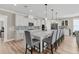 Elegant kitchen with white cabinets, quartz countertops, backsplash, and seating around a large island at 105 Bluff Isle Ct, Summerville, SC 29486