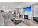 Cozy living room features a fireplace, a large sectional couch, and a view into the modern kitchen at 105 Bluff Isle Ct, Summerville, SC 29486