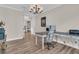 Bright home office with wood floors, white trim, chandelier, and a view into the kitchen at 105 Bluff Isle Ct, Summerville, SC 29486