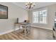 Well-lit home office features a large window, wood floors, and a classic desk and chair at 105 Bluff Isle Ct, Summerville, SC 29486