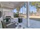 Inviting covered patio with fire pit, seating, and views of the lake and backyard at 105 Bluff Isle Ct, Summerville, SC 29486