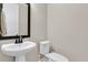 Elegant powder room with pedestal sink, toilet, and modern framed mirror at 105 Bluff Isle Ct, Summerville, SC 29486