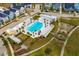 A picturesque aerial view of the community pool, playground, and surrounding residences and landscaping at 107 Nutmeg Way, Summerville, SC 29485