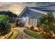 Private backyard with a hot tub, built-in grill, and charming landscaping on a stone and grass walkway at 107 Nutmeg Way, Summerville, SC 29485