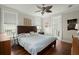 Cozy bedroom features a leaf-design ceiling fan, wood flooring, and an ensuite bathroom at 107 Nutmeg Way, Summerville, SC 29485