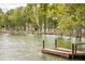 A serene shot of a wooden dock leading into a tranquil lake at 107 Nutmeg Way, Summerville, SC 29485