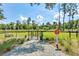 Fenced dog park featuring a grassy area, picnic table and dedicated spaces for furry friends to play at 107 Nutmeg Way, Summerville, SC 29485