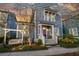 Two-story home with a red front door, white trim, a white porch swing and manicured landscaping at 107 Nutmeg Way, Summerville, SC 29485