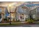 Two-story home featuring a red front door, white trim, and a swing in the landscaped yard at 107 Nutmeg Way, Summerville, SC 29485