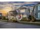 Charming two-story home with a red front door and landscaped yard at dusk at 107 Nutmeg Way, Summerville, SC 29485