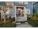 View of the front porch with a bright red door, white trim, and neat landscaping at 107 Nutmeg Way, Summerville, SC 29485