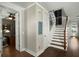 Hallway with hardwood floors, white trim, and stairs with wood railing at 107 Nutmeg Way, Summerville, SC 29485