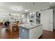 Open concept kitchen with a granite island, modern lighting, and views into the living and dining areas at 107 Nutmeg Way, Summerville, SC 29485