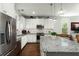 Stylish kitchen with stainless steel appliances, white cabinets, granite countertops, and hardwood flooring at 107 Nutmeg Way, Summerville, SC 29485