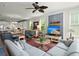 Open-concept living area with hardwood floors, a comfortable seating area, and a view into the modern kitchen at 107 Nutmeg Way, Summerville, SC 29485