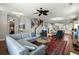 Inviting living room featuring a large sectional sofa, hardwood floors, and an eye-catching ceiling fan at 107 Nutmeg Way, Summerville, SC 29485