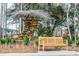 A peaceful park setting featuring a unique wooden structure and a comfortable bench to relax at 107 Nutmeg Way, Summerville, SC 29485