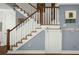 Charming staircase with white railing and stained wood detail, accented by a sliding barn door at 107 Nutmeg Way, Summerville, SC 29485