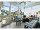 Bright and airy sunroom with comfortable seating, ceiling fan and lots of natural light at 107 Nutmeg Way, Summerville, SC 29485