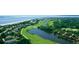 An aerial view features a lush golf course winding through the community near the ocean at 1153 Summerwind Ln, Seabrook Island, SC 29455