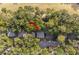 Aerial view of the house, surrounded by lush greenery, trees, and a golf course at 1153 Summerwind Ln, Seabrook Island, SC 29455