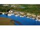 Aerial view of the marina and surrounding landscape, with boats docked and buildings nearby at 1153 Summerwind Ln, Seabrook Island, SC 29455