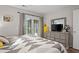 Comfortable bedroom boasts a dresser and mirror, with a balcony view at 1153 Summerwind Ln, Seabrook Island, SC 29455