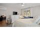Bright bedroom featuring a cozy bed, white dresser with TV, and access to the screened patio at 1153 Summerwind Ln, Seabrook Island, SC 29455