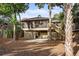 Exterior view of the home with a screened porch, stairs, and landscaped yard at 1153 Summerwind Ln, Seabrook Island, SC 29455