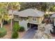 Charming home exterior with mature trees and a well-maintained driveway at 1153 Summerwind Ln, Seabrook Island, SC 29455
