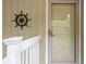 Close-up of the front door with nautical decor and white railing at 1153 Summerwind Ln, Seabrook Island, SC 29455
