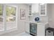 Mini beverage refrigerator, white cabinets and countertops make this butler's pantry shine! at 1153 Summerwind Ln, Seabrook Island, SC 29455