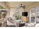 Relaxing screened patio with comfortable seating, TV, and view to interior bedroom through sliding glass door at 1153 Summerwind Ln, Seabrook Island, SC 29455