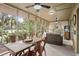Inviting screened-in patio featuring a dining area and seating area with views of lush greenery and golf course at 1153 Summerwind Ln, Seabrook Island, SC 29455