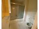 Modest bathroom featuring a bathtub with sliding glass doors, white tile floors, and a standard toilet at 116 W Johnston St, Summerville, SC 29483