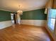 Charming dining room with hardwood floors, chandelier, wainscoting, and large window, ideal for entertaining at 116 W Johnston St, Summerville, SC 29483
