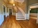 Grand foyer with hardwood floors, curved staircase, chandelier, and decorative trim, creating an elegant entry at 116 W Johnston St, Summerville, SC 29483
