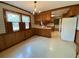 A kitchen features wood cabinets, white appliances, and a window with vintage decor at 116 W Johnston St, Summerville, SC 29483