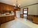 Cozy kitchen featuring wood cabinetry, vintage wallpaper, and a breakfast bar, offering a nostalgic charm at 116 W Johnston St, Summerville, SC 29483