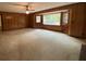 A living room presents bright windows, a ceiling fan, and wood paneled walls at 116 W Johnston St, Summerville, SC 29483