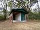 Exterior view of an outbuilding with a covered area and a small door at 116 W Johnston St, Summerville, SC 29483