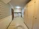 A room showcases vintage wallpaper, a door leading to a laundry area, and white storage at 116 W Johnston St, Summerville, SC 29483