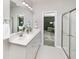 Well-lit bathroom with double vanity, modern fixtures, and a glass-enclosed shower with neutral color palette at 119 Royal Cainhoy Way, Huger, SC 29450