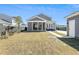 View of home exterior with fenced yard, and a cozy patio and screened porch at 123 Hewitt St, Summerville, SC 29486