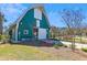 Exterior shot of a barn featuring a manicured garden and paved walkway at 123 Hewitt St, Summerville, SC 29486