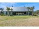 View of exterior of green barn with palm trees in manicured yard at 123 Hewitt St, Summerville, SC 29486